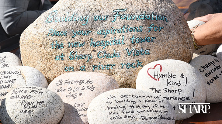 Event attendees wrote their aspirations for the new hospital tower on river rocks. These rocks will be included in the final stages of construction for the new tower's foundation.